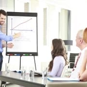 man using whiteboard to show graph to others